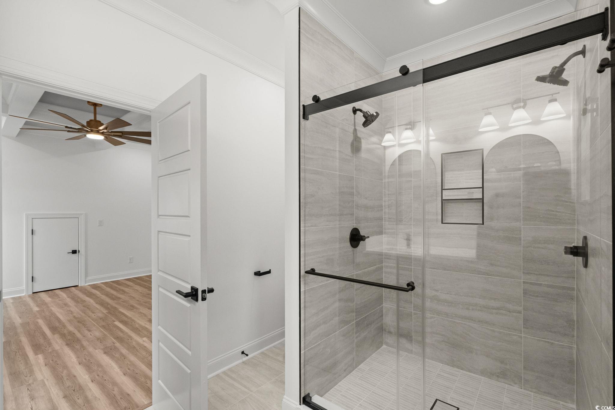 164 Arbor Ridge Circle Conway, SC 29526 - Photo 24 of 38 Bathroom with crown molding, a stall shower, a ceiling fan, and light wood-type flooring