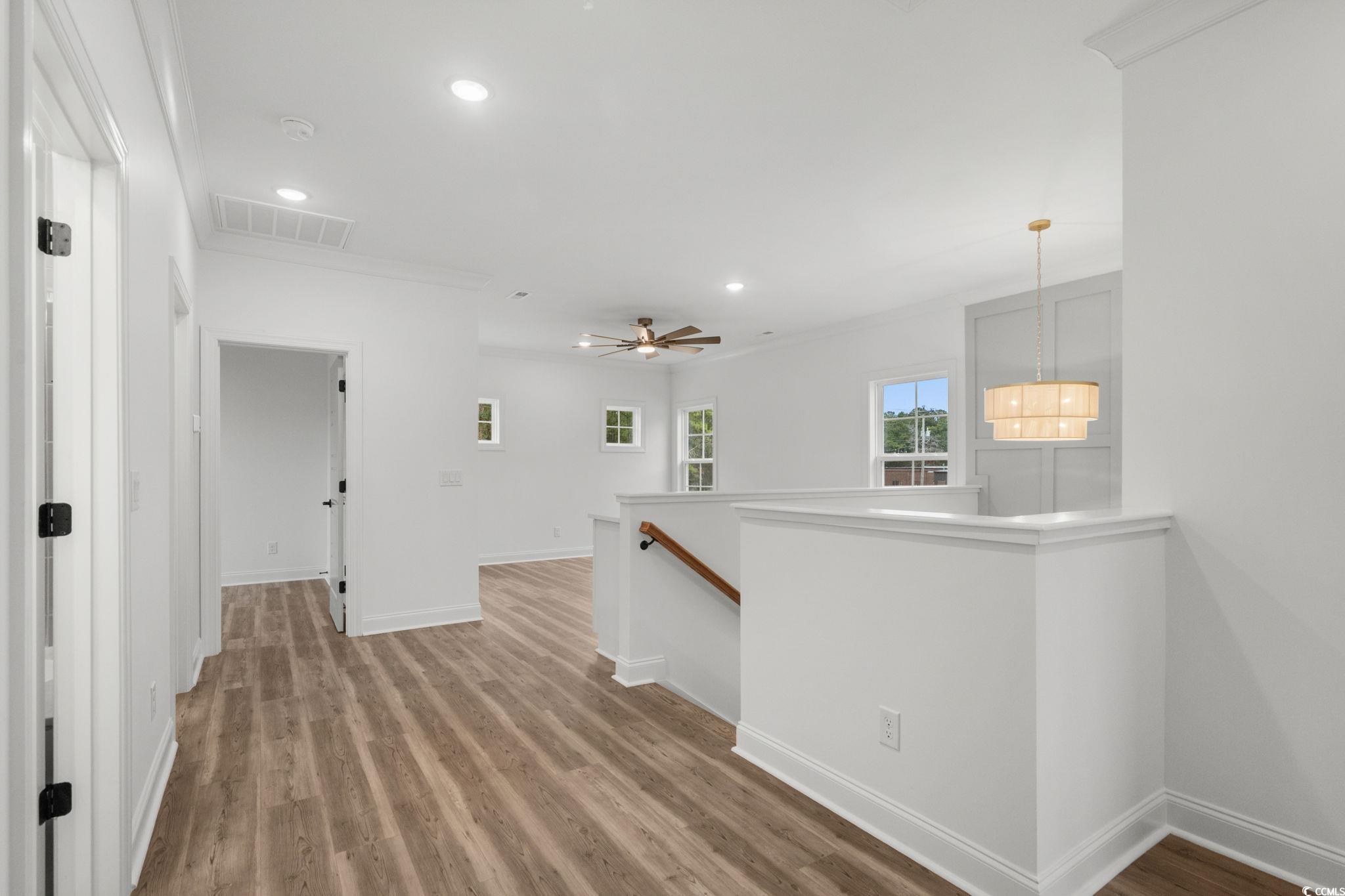 164 Arbor Ridge Circle Conway, SC 29526 - Photo 26 of 38 Corridor with an upstairs landing, recessed lighting, light wood-style flooring, and crown molding