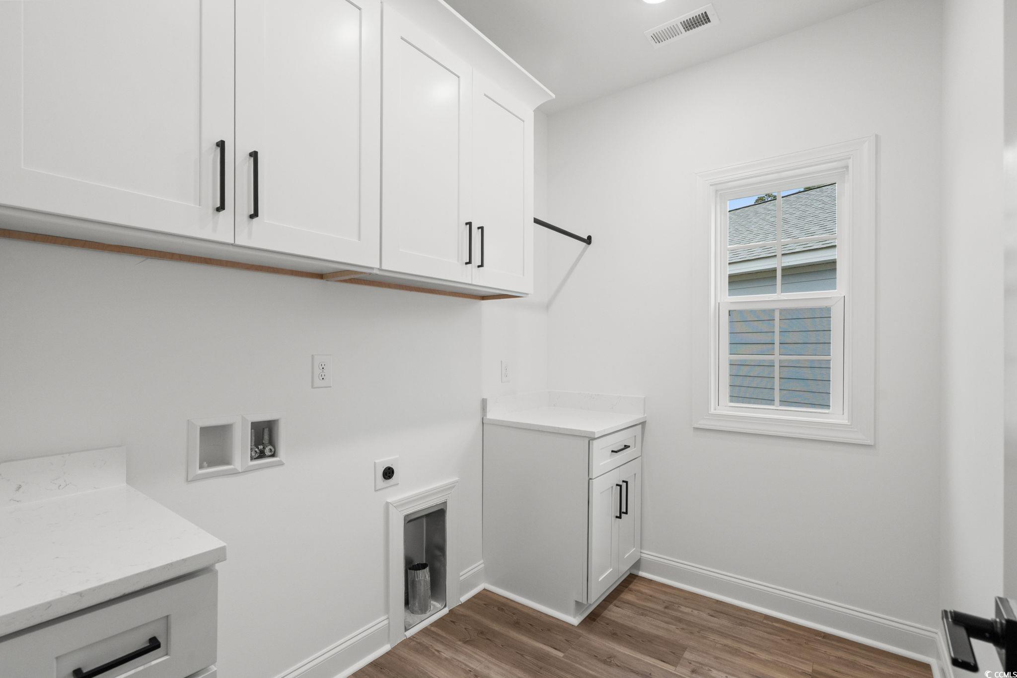 164 Arbor Ridge Circle Conway, SC 29526 - Photo 37 of 38 Washroom featuring washer hookup, dark wood-style flooring, hookup for an electric dryer, and cabinet space