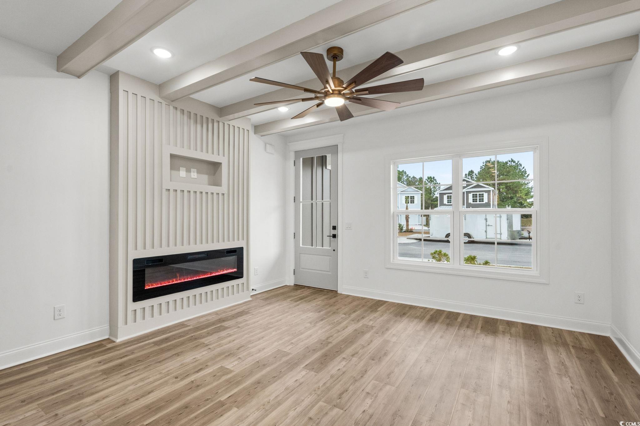 164 Arbor Ridge Circle Conway, SC 29526 - Photo 5 of 38 Unfurnished living room featuring beam ceiling, a ceiling fan, light wood-style floors, a glass covered fireplace, and recessed lighting