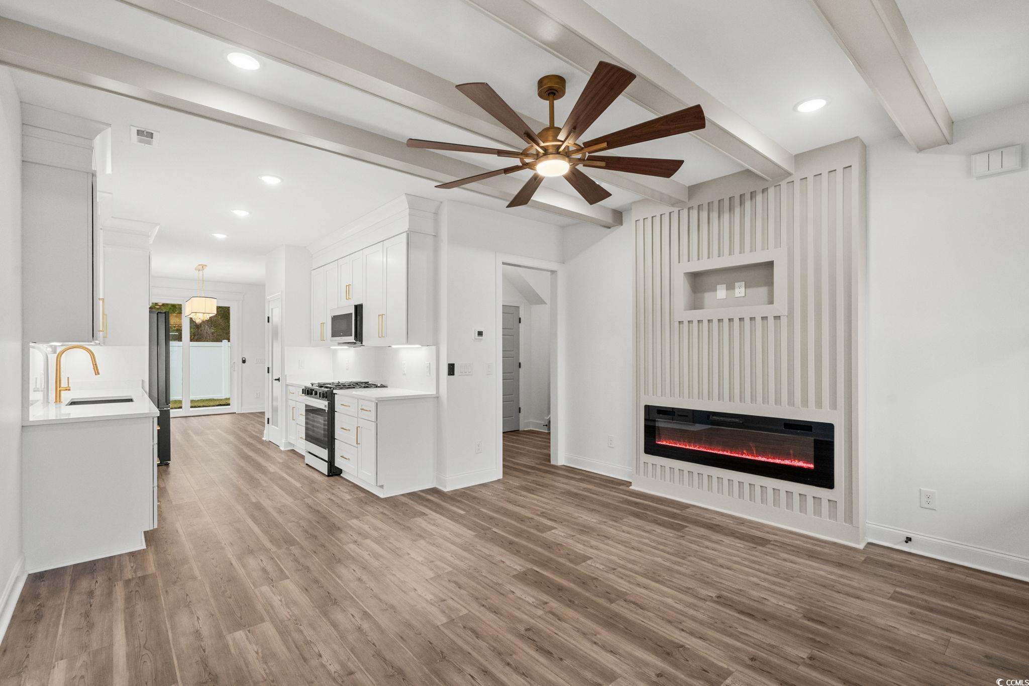 164 Arbor Ridge Circle Conway, SC 29526 - Photo 6 of 38 Unfurnished living room featuring beam ceiling, ceiling fan, light wood-style flooring, a glass covered fireplace, and recessed lighting