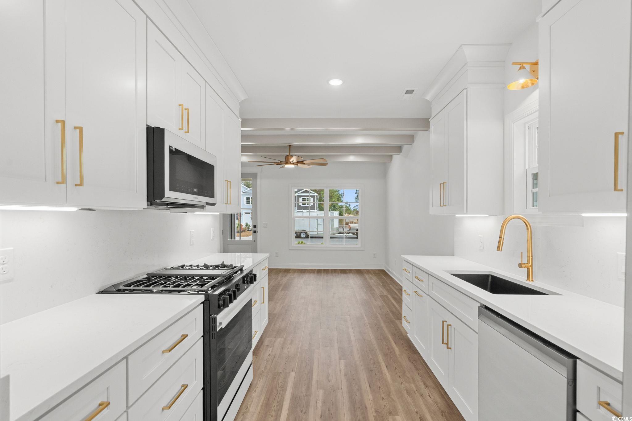 164 Arbor Ridge Circle Conway, SC 29526 - Photo 9 of 38 Kitchen with gas stove, white cabinetry, stainless steel dishwasher, white microwave, and recessed lighting