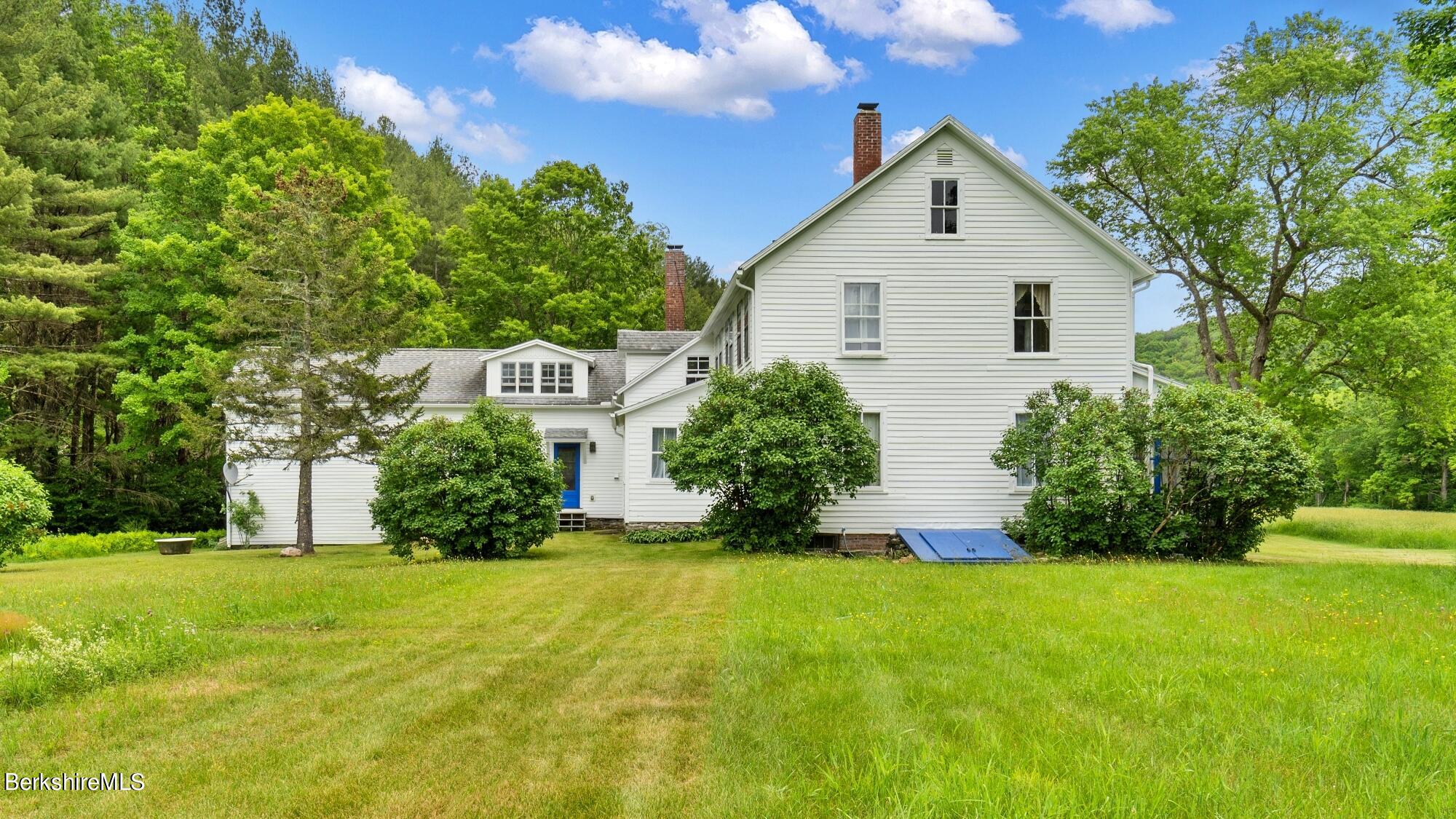 601 East River Road Chester, MA 01050 - Photo 41 of 49 a front view of house with yard and green space