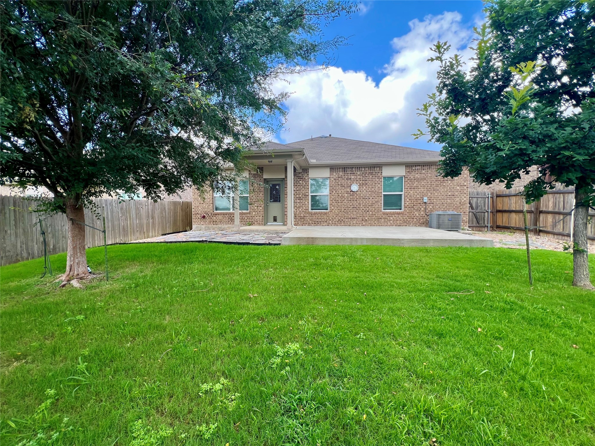 104 Moravia Road Georgetown, TX 78626 - Photo 33 of 36 A spacious grassy yard extends to a generous patio, perfect for outdoor enjoyment.