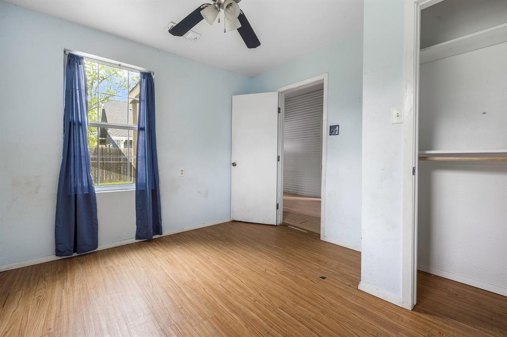 719 West Tarleton Street Stephenville, TX 76401 - Photo 15 of 30 an empty room with wooden floor and windows