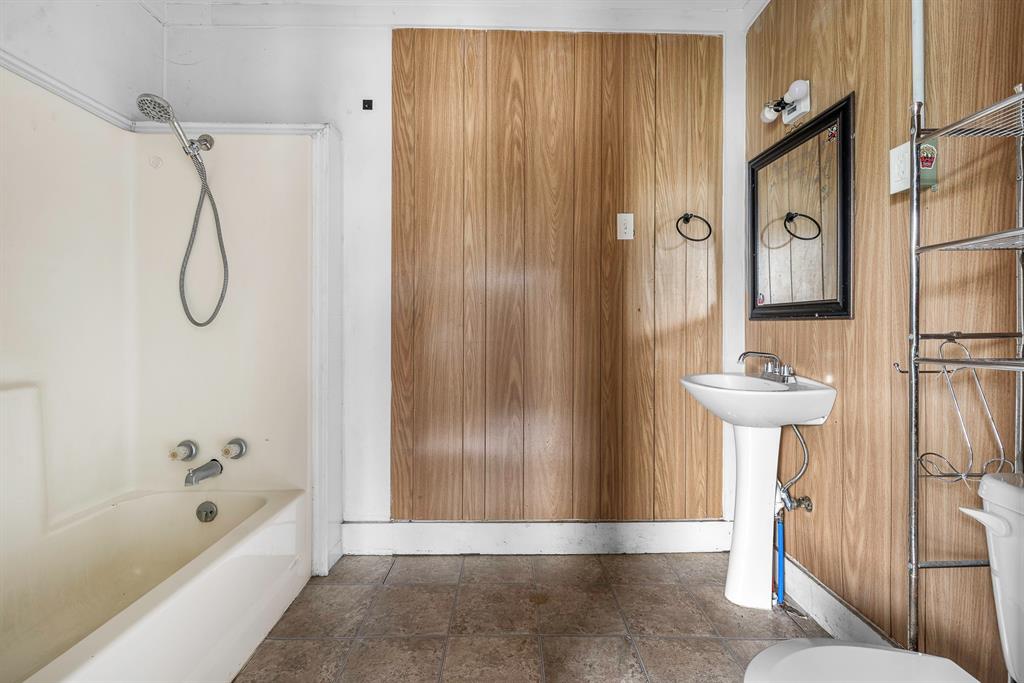 719 West Tarleton Street Stephenville, TX 76401 - Photo 25 of 30 a bathroom with a shower and a sink