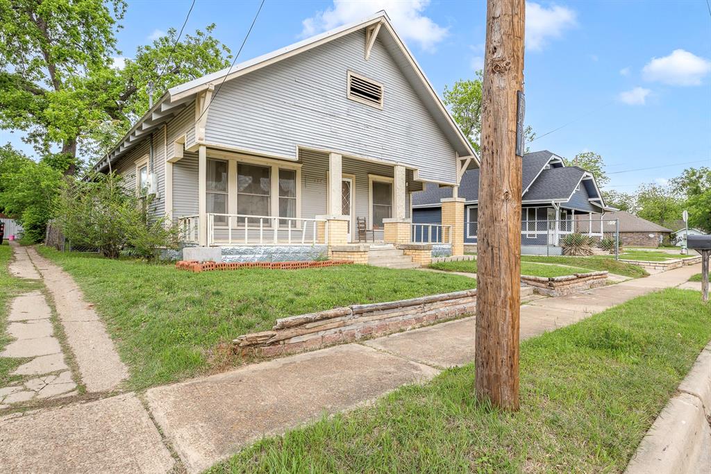 719 West Tarleton Street Stephenville, TX 76401 - Photo 3 of 30 a front view of a house with a yard and table and chairs