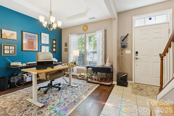 a living room with furniture a table and large windows