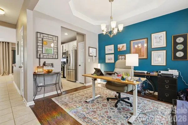 a living room with furniture a table and wooden floor