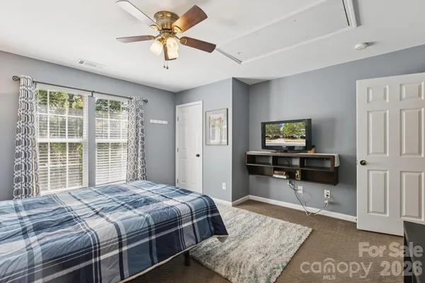 a bedroom with a bed and a television
