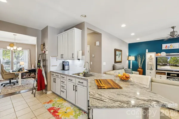 a large white kitchen with a large window