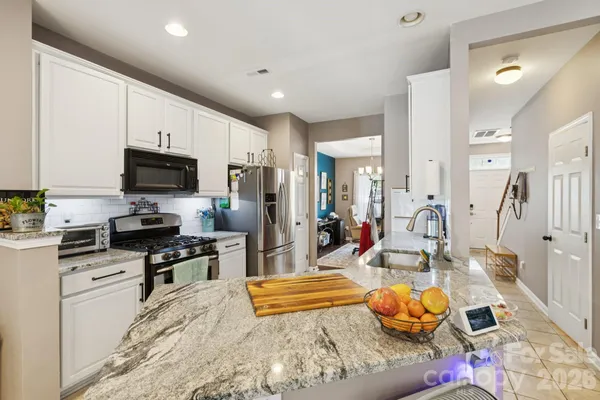 a kitchen with stainless steel appliances kitchen island granite countertop a sink and cabinets