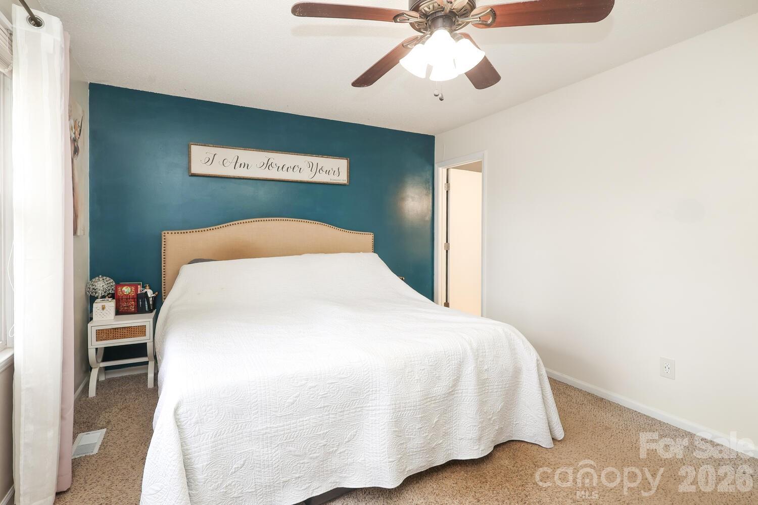 210 King George Lane Gastonia, NC 28056 - Photo 12 of 19 a bedroom with a bed and a chandelier