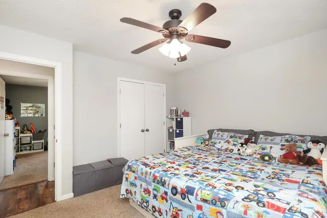 a view of a house with backyard and tree