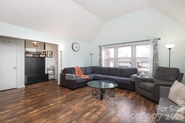 a living room with a fireplace and a flat screen tv