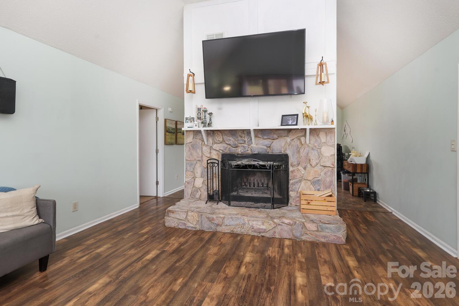 210 King George Lane Gastonia, NC 28056 - Photo 5 of 19 a living room with a fireplace and a flat screen tv