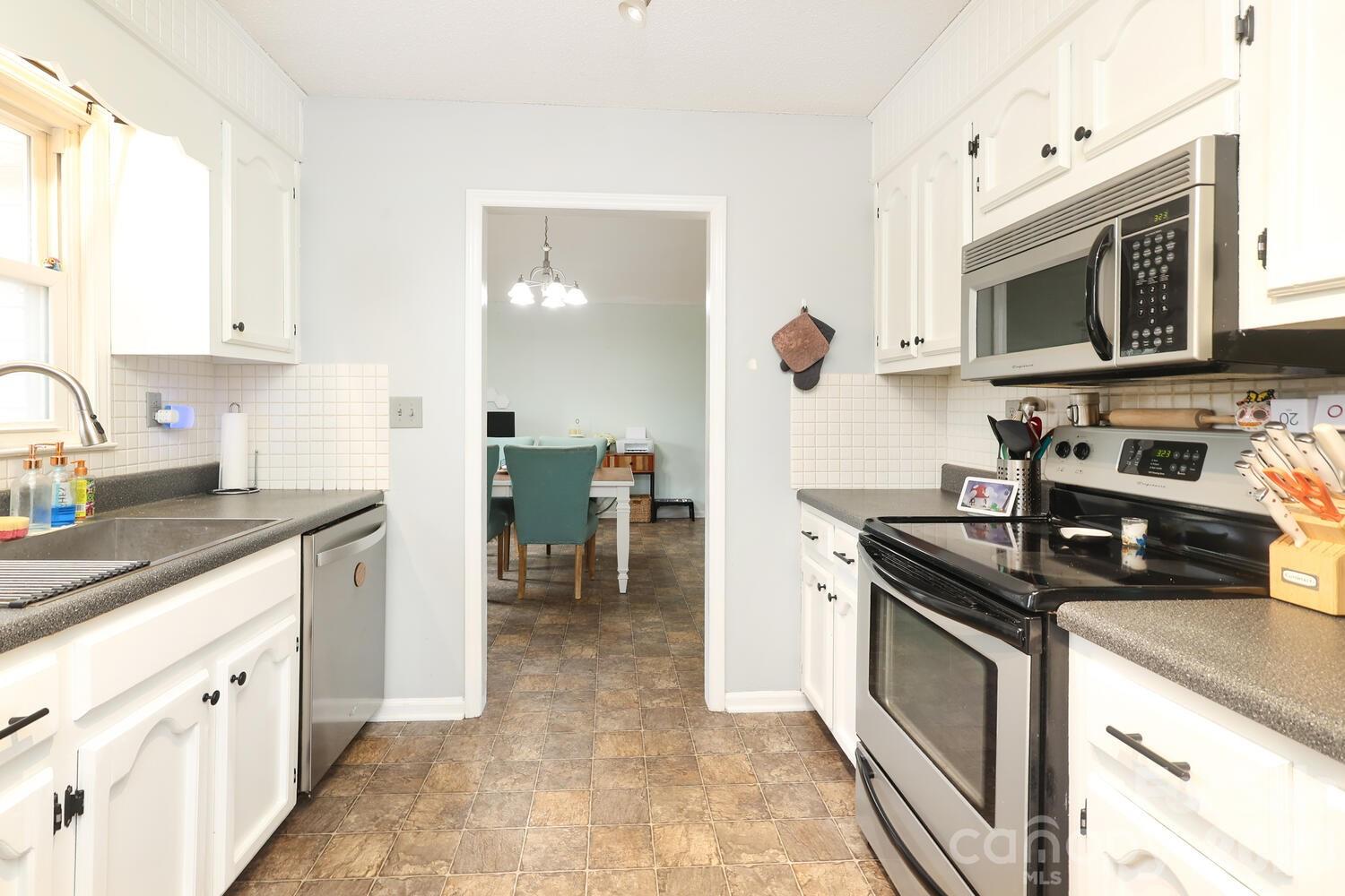 210 King George Lane Gastonia, NC 28056 - Photo 10 of 19 a kitchen with stainless steel appliances granite countertop a sink and a stove