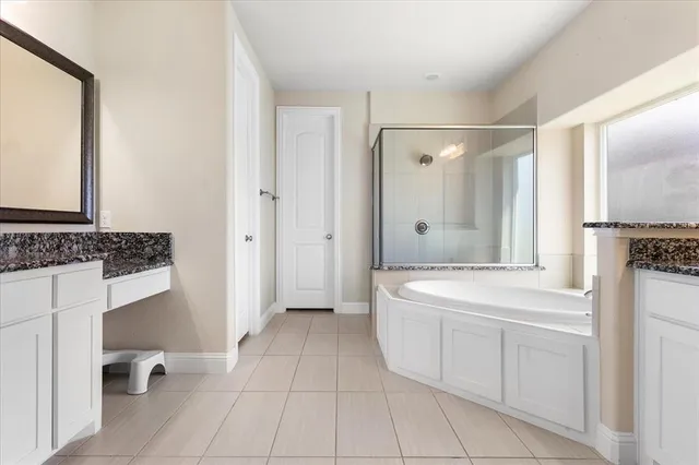 a spacious bathroom with a tub shower and sink