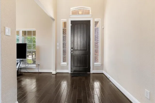 a view of front door with wooden floor