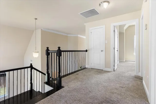 a view of a hallway with stairs