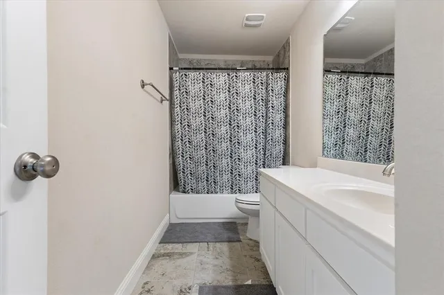 a view of a house with a yard and pathway