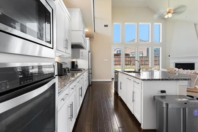 a kitchen with stainless steel appliances granite countertop a sink and stove