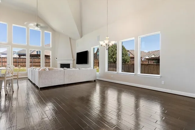 a living room with furniture and large windows