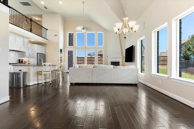 a living room with fireplace furniture and a wooden floor