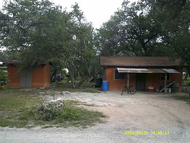 a view of a house with a car parked in garage
