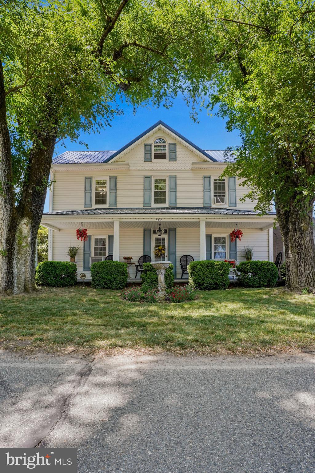 7215 Benedict Avenue Benedict, MD 20612 - Photo 11 of 47 a front view of a house with a garden