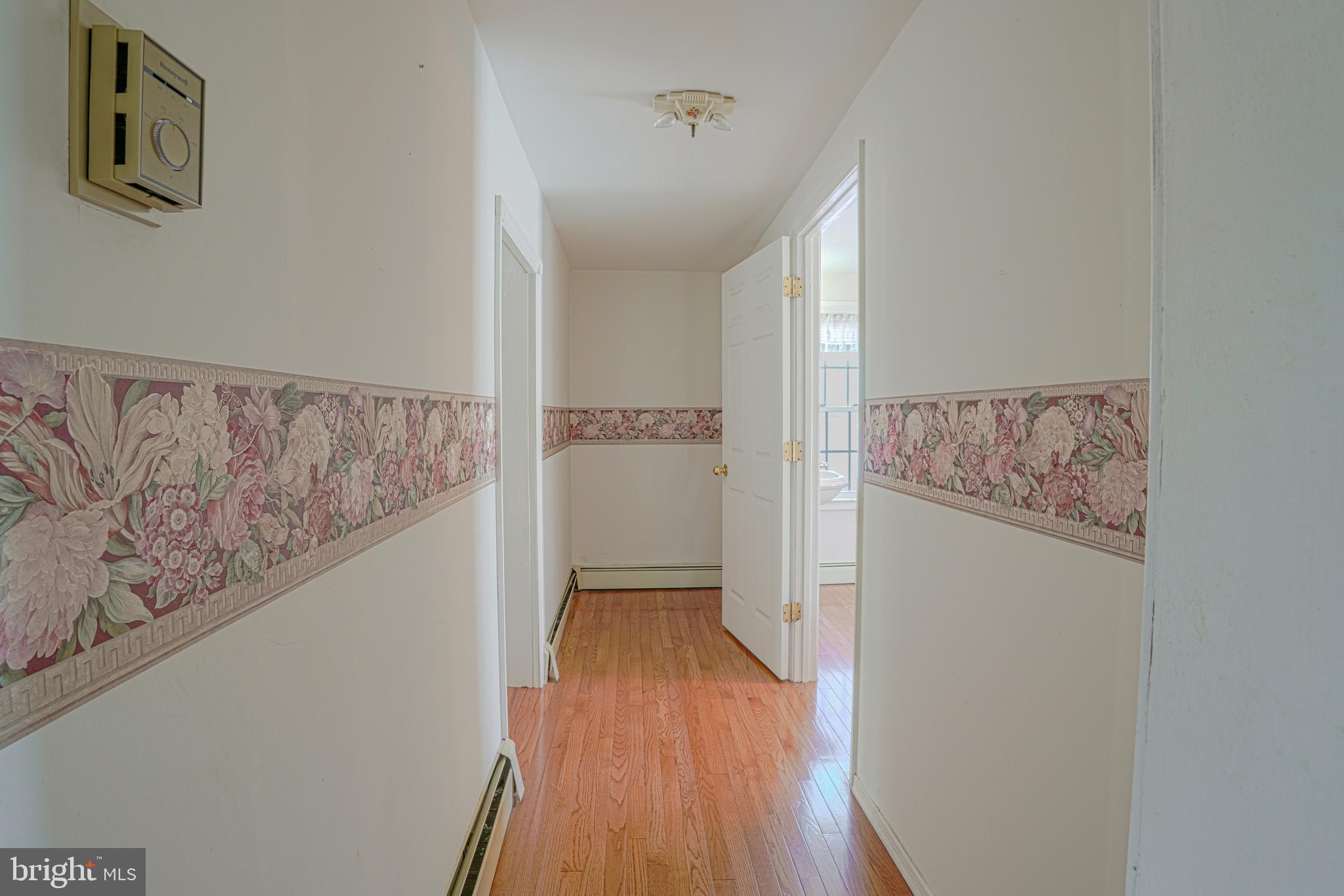 7215 Benedict Avenue Benedict, MD 20612 - Photo 30 of 47 a view of a hallway with wooden floor and entryway