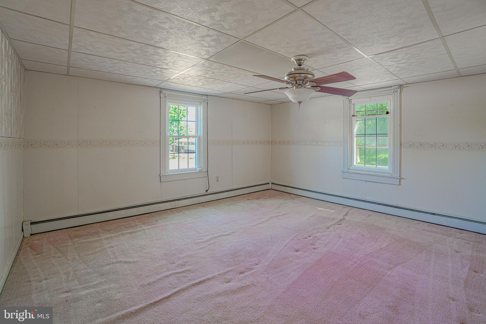 7215 Benedict Avenue Benedict, MD 20612 - Photo 39 of 47 an empty room with windows and fan