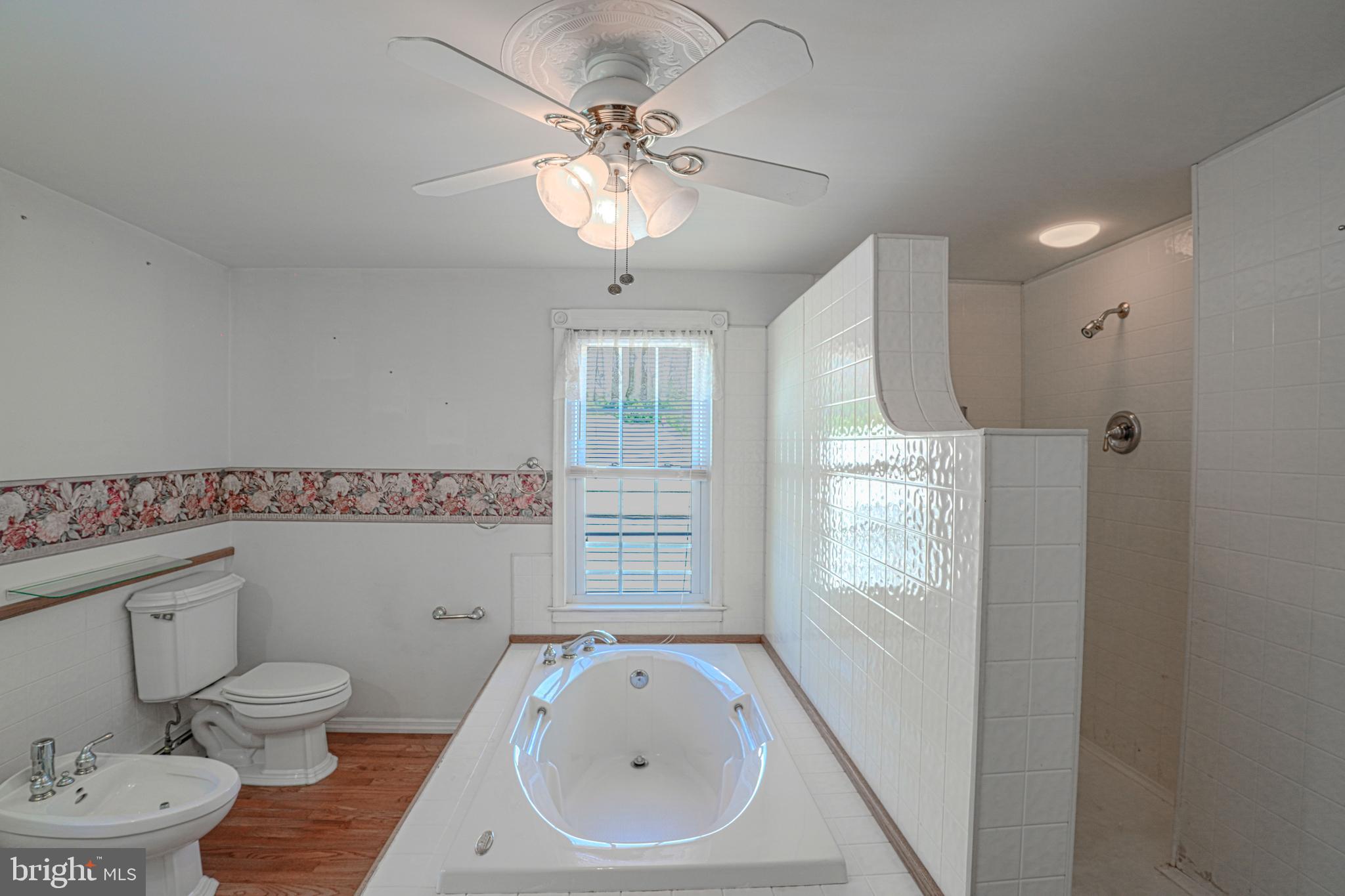 7215 Benedict Avenue Benedict, MD 20612 - Photo 42 of 47 a bathroom with a sink a toilet and shower