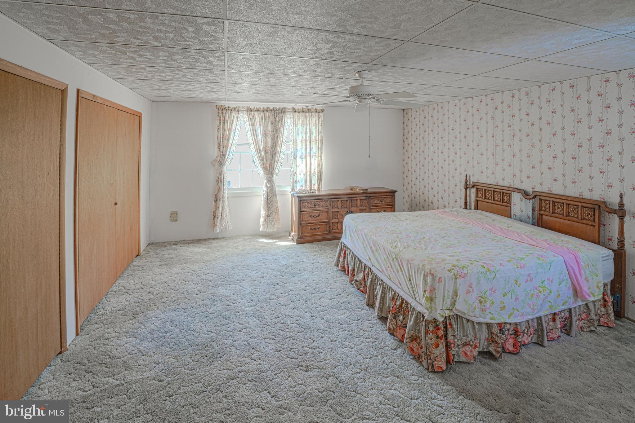 7215 Benedict Avenue Benedict, MD 20612 - Photo 43 of 47 a spacious bedroom with a bed and a walk in closet