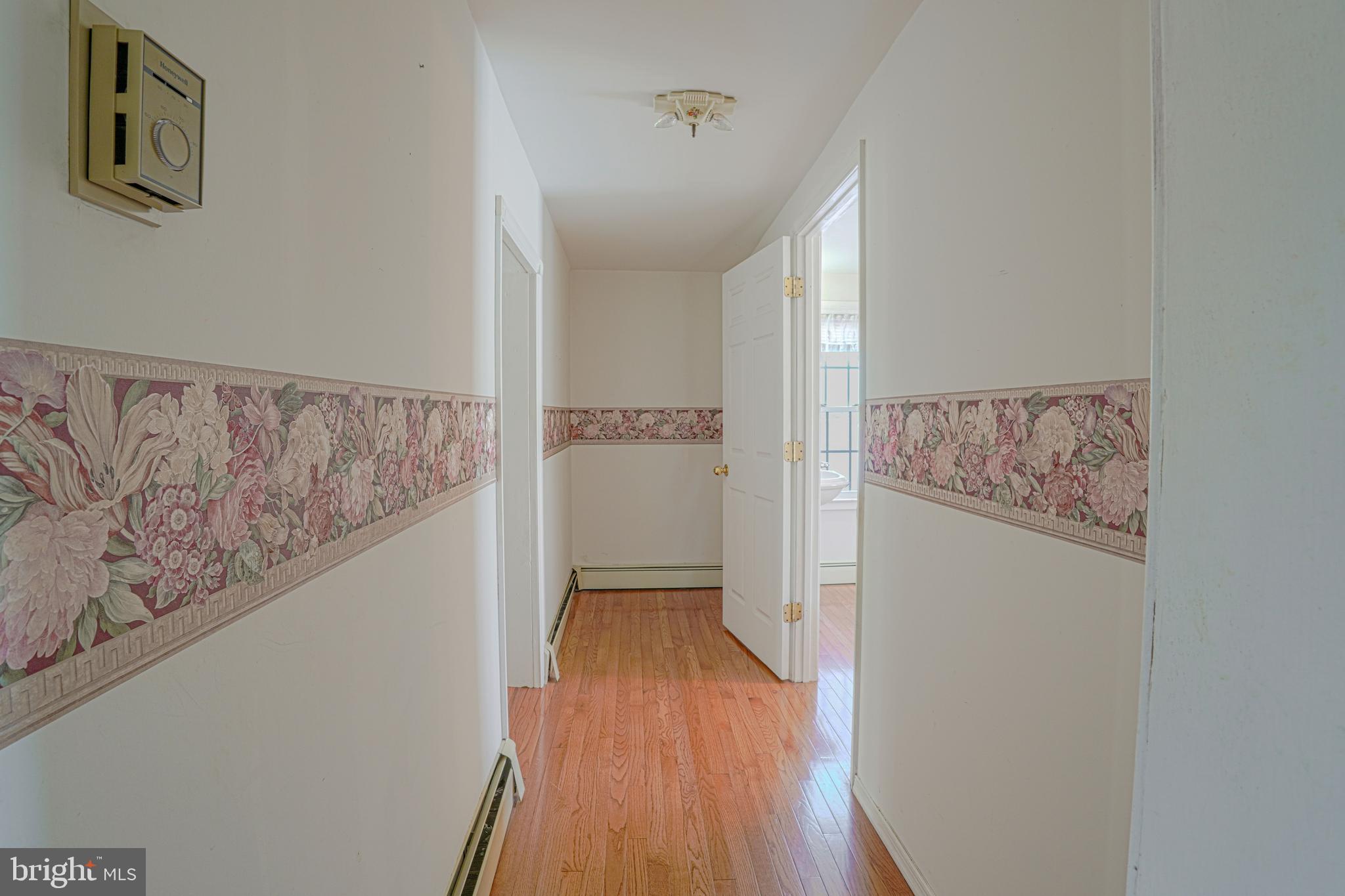 7215 Benedict Avenue Benedict, MD 20612 - Photo 45 of 47 a view of a hallway with wooden floor and entryway
