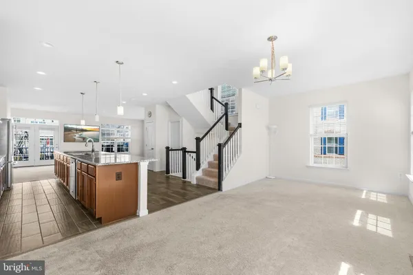 a large kitchen with stainless steel appliances granite countertop plenty wooden cabinets counter space a sink and a center island