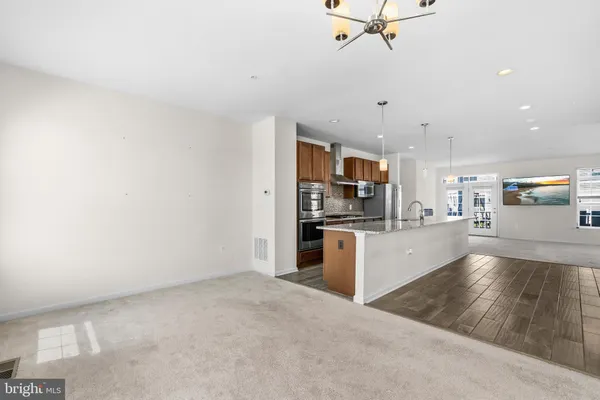 a view of a kitchen with a sink and a refrigerator