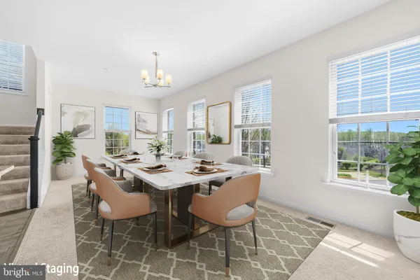 a view of a big room with windows and chandelier fan