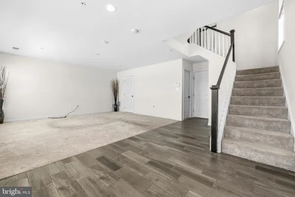 an empty room with windows and chandelier