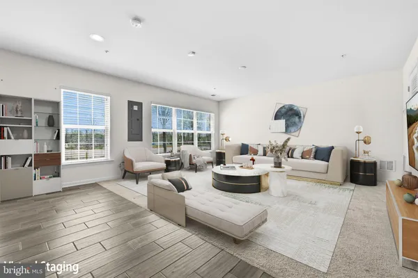 a kitchen with stainless steel appliances kitchen island granite countertop a refrigerator a sink and a wooden floors