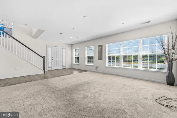 a large kitchen with stainless steel appliances a refrigerator and a stove top oven