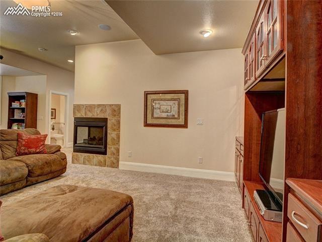 15925 Winding Trail Road Colorado Springs, CO 80908 - Photo 32 of 36 2nd Family Room in Basement with Fireplace
