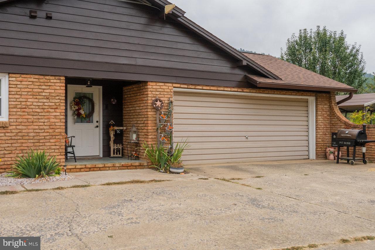120 Galen Hedrick Road Franklin, WV 26807 - Photo 109 of 115 a front view of a house with a yard and garage