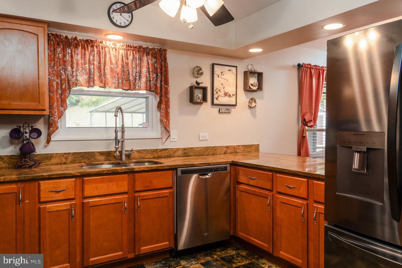 120 Galen Hedrick Road Franklin, WV 26807 - Photo 30 of 115 a kitchen with stainless steel appliances granite countertop a refrigerator and a sink