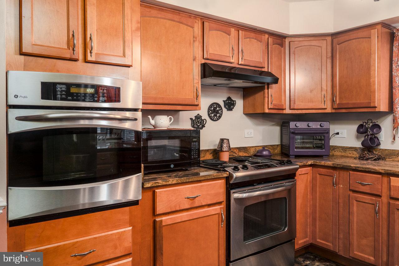 120 Galen Hedrick Road Franklin, WV 26807 - Photo 33 of 115 a kitchen with stainless steel appliances granite countertop a stove and a microwave
