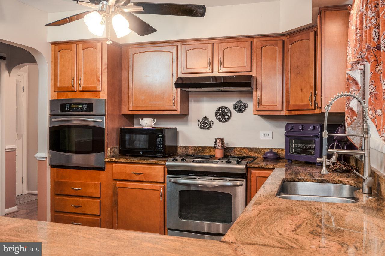 120 Galen Hedrick Road Franklin, WV 26807 - Photo 34 of 115 a kitchen with stainless steel appliances granite countertop a stove a sink and a microwave
