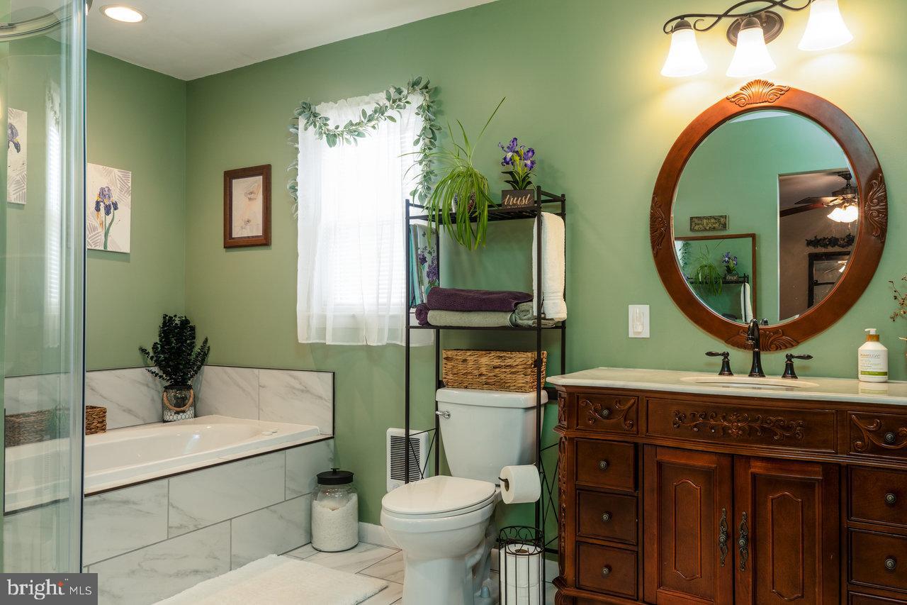 120 Galen Hedrick Road Franklin, WV 26807 - Photo 45 of 115 a bathroom with a toilet a sink and a mirror