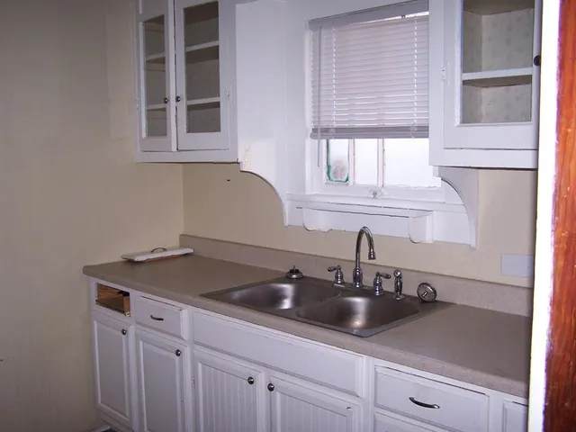 a kitchen with a sink and cabinets