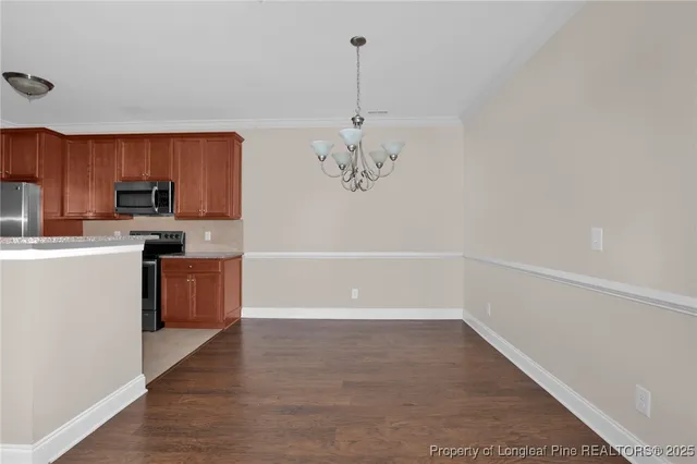 a kitchen with a refrigerator a stove top oven a sink and dishwasher