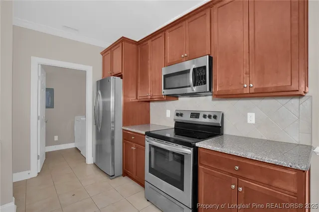 a kitchen with granite countertop wooden cabinets stainless steel appliances and a granite counter tops